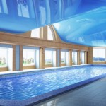 Pool inside the house. Glossy ceiling. Large home pool. Blue luxury pool